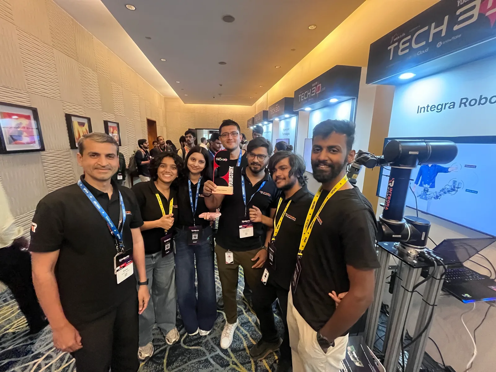 The Integra Robotics team with the Tech30 2026 award at their booth