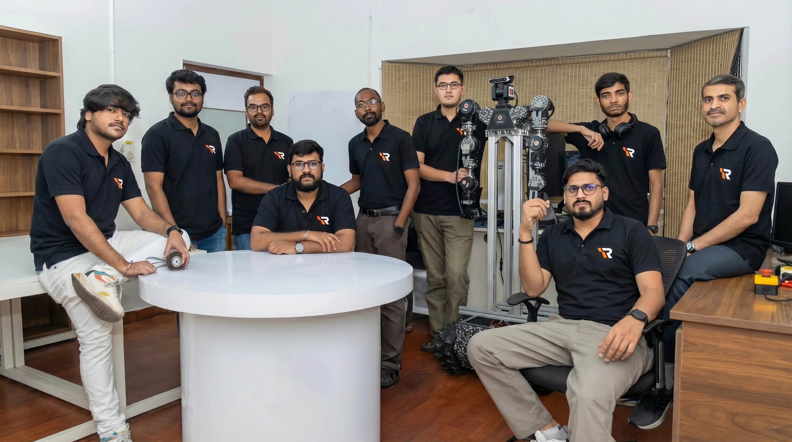 Integra Robotics team with their robot arm